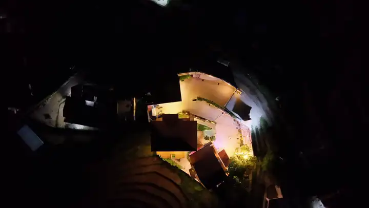 Aerial view of the property's A-frame roofline against the forested hillside